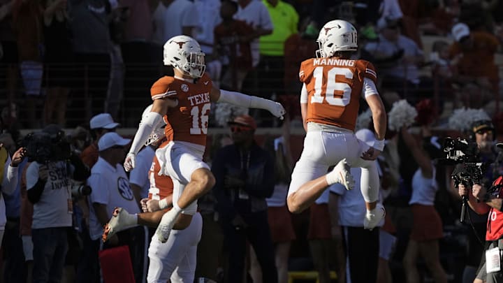 Texas Longhorns quarterback Arch Manning and defensive back Michael Taaffe react after a touchdown