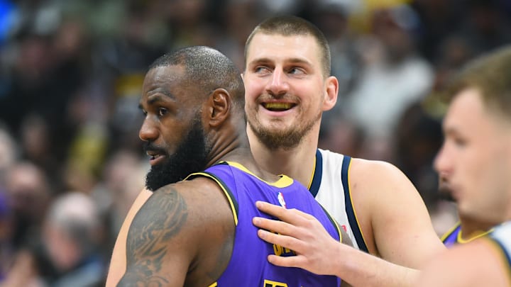 Feb 22, 2025; Denver, Colorado, USA; Denver Nuggets center Nikola Jokic (15) and Los Angeles Lakers forward LeBron James (23) hug before the game at Ball Arena.