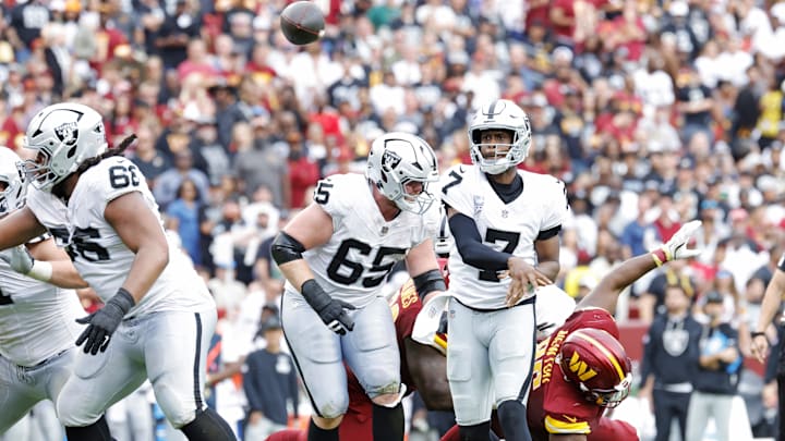 Sep 21, 2025; Landover, Maryland, USA; Las Vegas Raiders quarterback Geno Smith (7) throws a touchdown pass during the second half against the Washington Commanders at Northwest Stadium. Mandatory Credit: Amber Searls-Imagn Images