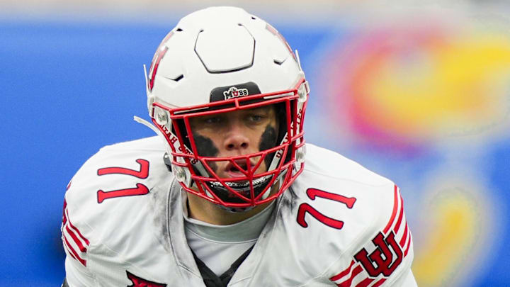 Utah Utes offensive lineman Caleb Lomu (71) gets ready before the snap during the second half against the Kansas Jayhawks Utah Utes offensive lineman Caleb Lomu (71) gets ready before the snap during the second half against the Kansas Jayhawks