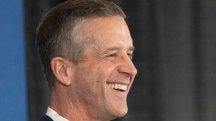 New Giants Head Coach John Harbaugh holds up a New York Giants helmet during a press conference welcoming Harbaugh at the Quest Diagnostics Training Center in East Rutherford on Tuesday, Jan. 20, 2025.