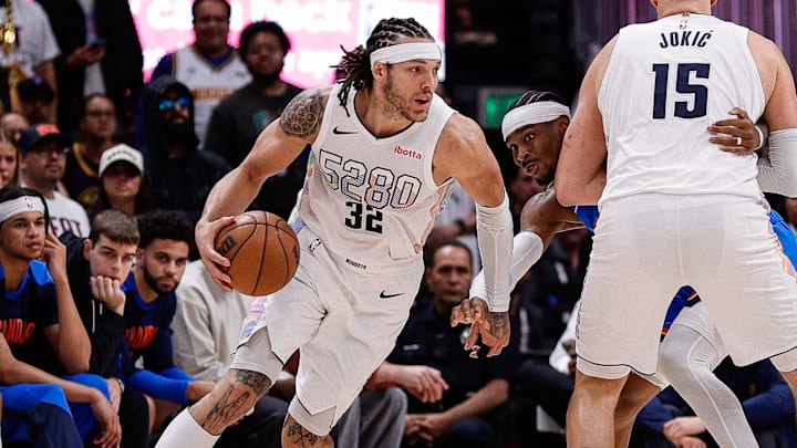 Denver Nuggets forward Gordon controls the ball as center Jokic screens against the Oklahoma City Thunder.