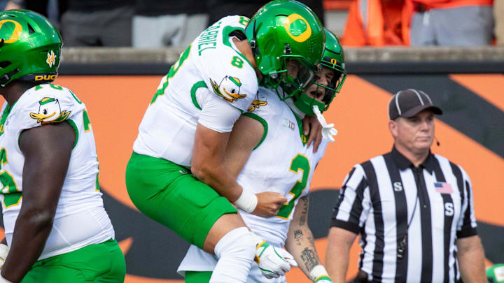 Oregon quarterback Dillon Gabriel celebrates a touchdown with Oregon tight end Terrance Ferguson as the Oregon State Beavers host the Oregon Ducks Saturday, Sept. 14, 2024 at Reser Stadium in Corvallis, Ore.