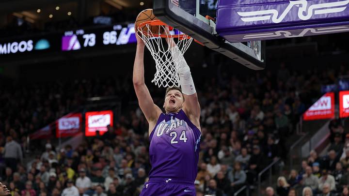 Feb 12, 2025; Salt Lake City, Utah, USA;  Utah Jazz center Walker Kessler (24) dunks against Los Angeles Lakers forward Lebron James (23) during the second half at Delta Center. Mandatory Credit: Chris Nicoll-Imagn Images