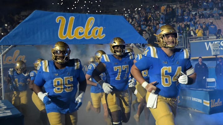 Nov 22, 2025; Pasadena, California, USA;  UCLA Bruins run on to the field for the game against the Washington Huskies at the Rose Bowl. Mandatory Credit: Jayne Kamin-Oncea-Imagn Images