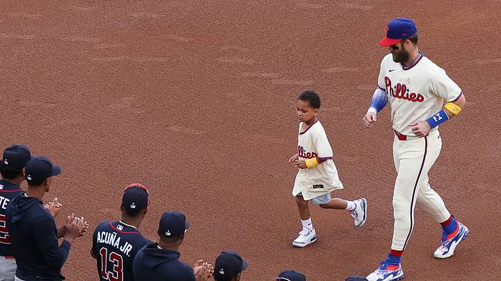Sep 6, 2026; Philadelphia, Pennsylvania, USA; Jeremiah L. Is escorted around the bases by Philadelphia Phillies first baseman Bryce Harper (3) in front of Atlanta Braves players on MLB Childhood Cancer Awareness Day at Citizens Bank Park. Mandatory Credit: Bill Streicher-Imagn Images Sep 6, 2026; Philadelphia, Pennsylvania, USA; Jeremiah L. Is escorted around the bases by Philadelphia Phillies first baseman Bryce Harper (3) in front of Atlanta Braves players on MLB Childhood Cancer Awareness Day at Citizens Bank Park. Mandatory Credit: Bill Streicher-Imagn Images