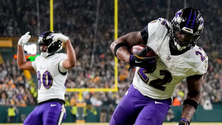 Baltimore Ravens running back Derrick Henry (22) runs for one of his three first-half touchdowns against the Packers.