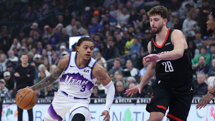 Nov 30, 2025; Salt Lake City, Utah, USA; Utah Jazz guard Keyonte George (3) drives against Houston Rockets center Alperen Sengun (28) during the first half at Delta Center. Mandatory Credit: Rob Gray-Imagn Images