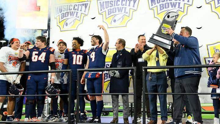 Dec 30, 2025; Nashville, TN, USA; Illinois Fighting Illini head coach Bret Bielema hoist the trophy against the Tennessee Volunteers during the second half at Nissan Stadium. Mandatory Credit: Steve Roberts-Imagn Images Dec 30, 2025; Nashville, TN, USA; Illinois Fighting Illini head coach Bret Bielema hoist the trophy against the Tennessee Volunteers during the second half at Nissan Stadium. Mandatory Credit: Steve Roberts-Imagn Images