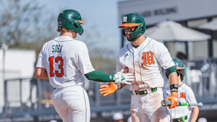 Miami Hurricanes catcher Alex Sosa (13) and right fielder Derek Williams (2) against Lafayette 