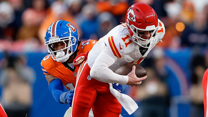 Jan 5, 2025; Denver, Colorado, USA; Kansas City Chiefs quarterback Carson Wentz (11) is sacked by Denver Broncos linebacker Nik Bonitto (15) in the third quarter at Empower Field at Mile High. 