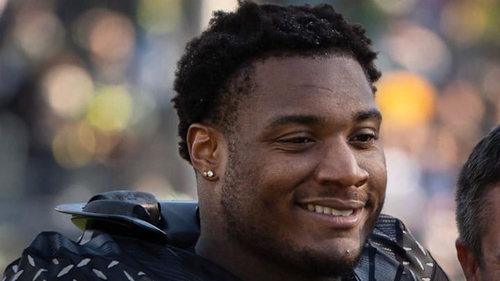 Oregon’s Isaiah World, left, takes a picture with coach Dan Lanning before the game against Southern California Nov. 22, 2025. Oregon’s Isaiah World, left, takes a picture with coach Dan Lanning before the game against Southern California Nov. 22, 2025.