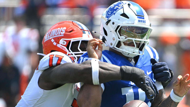Sep 6, 2025; Durham, North Carolina, USA;  Illinois Fighting Illini linebacker Gabe Jacas (17) swats the ball from Duke Blue Devils quarterback Darian Mensah (10) during the second quarter at Wallace Wade Stadium. Mandatory Credit: Zachary Taft-Imagn Images