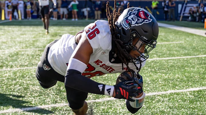 Oct 11, 2025; South Bend, Indiana, USA; NC State Wolfpack defensive back Asaad Brown Jr. (26) intercepts a pass in the end zone against the Notre Dame Fighting Irish during the first half at Notre Dame Stadium. Mandatory Credit: Michael Caterina-Imagn Images