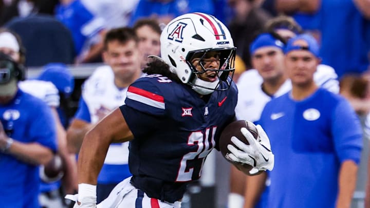 Oct 11, 2025; Tucson, Arizona, USA; Arizona Wildcats running back Quincy Craig (24) runs a first down during the first quarter of the game against the Brigham Young Cougars at Arizona Stadium. Mandatory Credit: Aryanna Frank-Imagn Images
