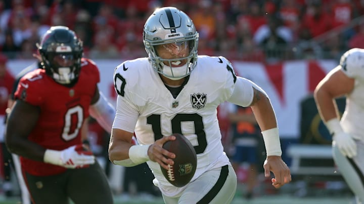 Dec 8, 2024; Tampa, Florida, USA; Las Vegas Raiders quarterback Desmond Ridder (10) runs with the ball against the Tampa Bay Buccaneers during the second half at Raymond James Stadium. Mandatory Credit: Kim Klement Neitzel-Imagn Images