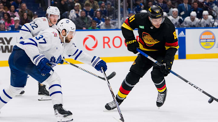 Jan 20, 2024; Vancouver, British Columbia, CAN; Toronto Maple Leafs defenseman Timothy Liljegren (37) and defenseman Jake McCabe (22) defend against Vancouver Canucks forward Dakota Joshua (81) in the third period at Rogers Arena. Canucks won 6-4. Mandatory Credit: Bob Frid-Imagn Images