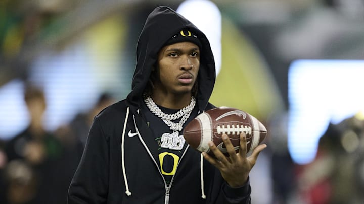 Nov 14, 2025; Eugene, Oregon, USA; Oregon Ducks wide receiver Dakorien Moore (1) watches teammates warm up before a game against the Minnesota Golden Gophers at Autzen Stadium. Mandatory Credit: Troy Wayrynen-Imagn Images Nov 14, 2025; Eugene, Oregon, USA; Oregon Ducks wide receiver Dakorien Moore (1) watches teammates warm up before a game against the Minnesota Golden Gophers at Autzen Stadium. Mandatory Credit: Troy Wayrynen-Imagn Images