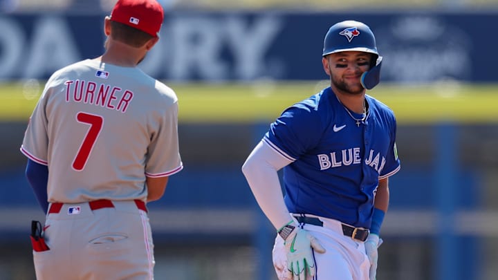 Mar 2, 2025; Dunedin, Florida, USA; Toronto Blue Jays shortstop Bo Bichette (11) reacts to Philadelphia Phillies shortstop Trea Turner (7) after a play in the first inning during spring training at TD Ballpark.