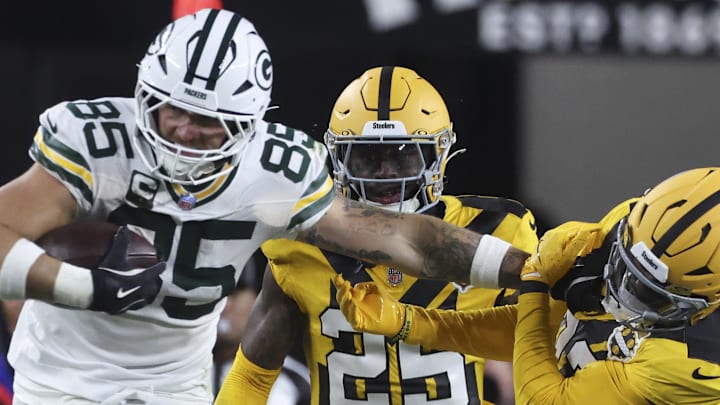Green Bay Packers tight end Tucker Kraft (85) stiff-arms Pittsburgh Steelers safety Juan Thornhill (22) during the third quarter. Green Bay Packers tight end Tucker Kraft (85) stiff-arms Pittsburgh Steelers safety Juan Thornhill (22) during the third quarter.