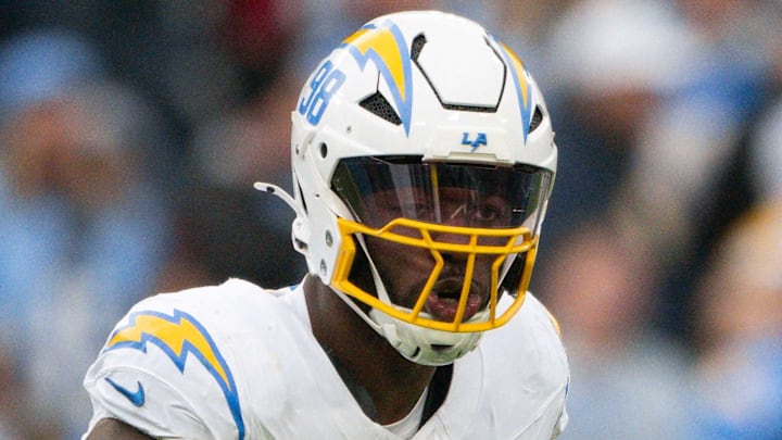 Nov 2, 2025; Nashville, Tennessee, USA;  Los Angeles Chargers linebacker Odafe Oweh (98) celebrates his sack with linebacker Tuli Tuipulotu (45) against the Tennessee Titans during the second half at Nissan Stadium. Mandatory Credit: Steve Roberts-Imagn Images
