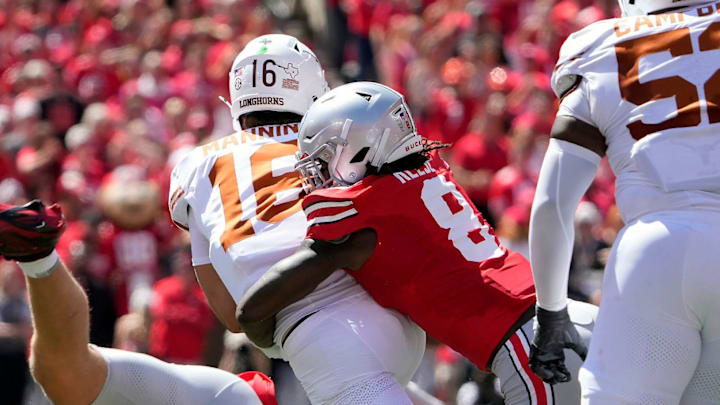 Ohio State Buckeyes linebacker Arvell Reese tackles Texas Longhorns quarterback Arch Manning
