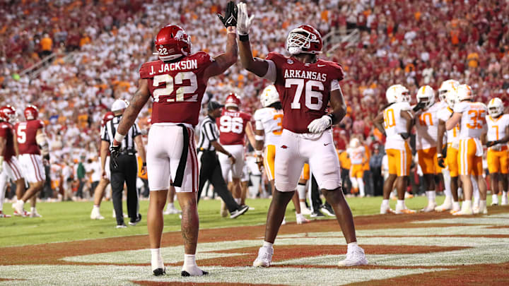 Arkansas Razorbacks running back Ja’Quinden Jackson (22) celebrates with offensive lineman E’Marion Harris (76) after scoring in the third quarter against the Tennessee Volunteers at Donald W. Reynolds Razorback Stadium. Harris transferred to Oklahoma in the offseason.