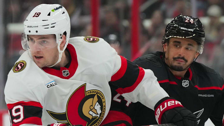 Apr 20, 2026; Raleigh, North Carolina, USA; Carolina Hurricanes center Seth Jarvis (24) and Ottawa Senators right wing Drake Batherson (19) battle in the first overtime period in game two of the first round of the 2026 Stanley Cup Playoffs at Lenovo Center. Mandatory Credit: James Guillory-Imagn Images