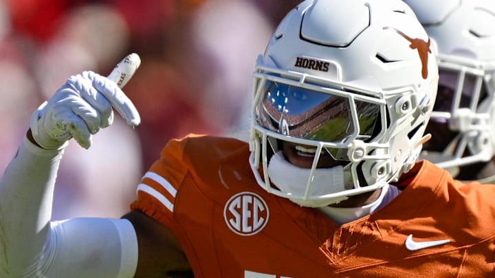Texas Longhorns defensive back Malik Muhammad celebrates after intercepting a pass against Oklahoma.