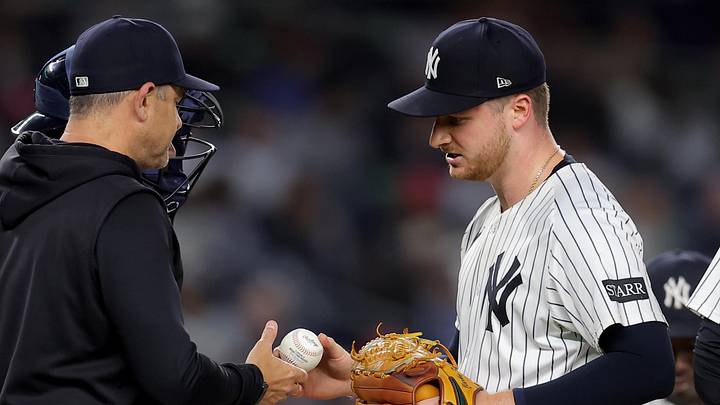 New York Yankees starting pitcher Clarke Schmidt (36) is taken out of the game by manager Aaron Boone (17) during the eighth inning against the Los Angeles Angels at Yankee Stadium.