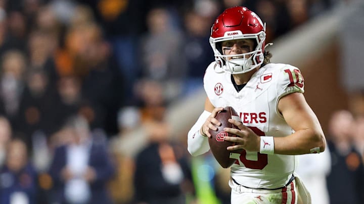 Oklahoma quarterback John Mateer rolls out to pass against Tennessee.