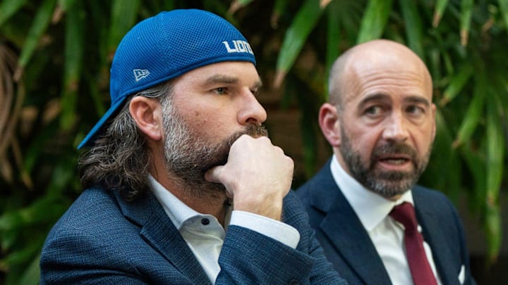 Detroit Lions fan Ryan Kennedy, center, listens during a press conference 