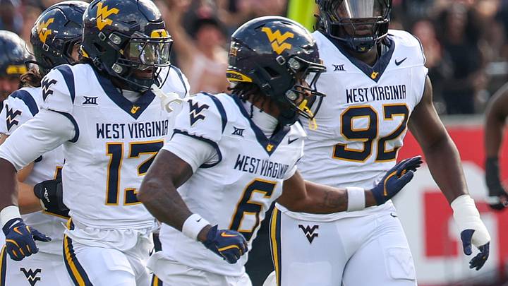 Nov 1, 2025; Houston, Texas, USA; Houston Cougars wide receiver Koby Young (18) is chased by West Virginia Mountaineers defensive back Jordan Scruggs (6) and teammates in the first half at TDECU Stadium. Mandatory Credit: Thomas Shea-Imagn Images Nov 1, 2025; Houston, Texas, USA; Houston Cougars wide receiver Koby Young (18) is chased by West Virginia Mountaineers defensive back Jordan Scruggs (6) and teammates in the first half at TDECU Stadium. Mandatory Credit: Thomas Shea-Imagn Images