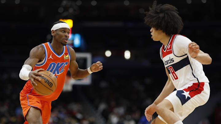 Jan 12, 2025; Washington, District of Columbia, USA; Oklahoma City Thunder guard Shai Gilgeous-Alexander (2) drives to the basket as Washington Wizards forward Kyshawn George (18) defends in the third quarter at Capital One Arena. Mandatory Credit: Geoff Burke-Imagn Images