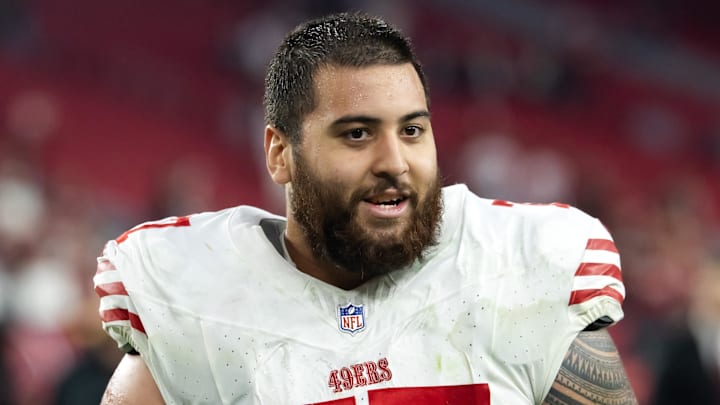 Jan 5, 2025; Glendale, Arizona, USA; San Francisco 49ers guard Dominick Puni (77) against the Arizona Cardinals at State Farm Stadium. Mandatory Credit: Mark J. Rebilas-Imagn Images