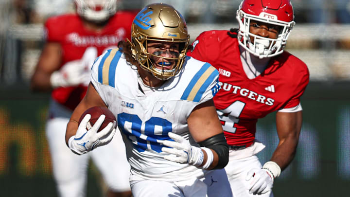 Oct 19, 2024; Piscataway, New Jersey, USA; UCLA Bruins tight end Moliki Matavao (88) gains yards after catch as Rutgers Scarlet Knights defensive back Desmond Igbinosun (4) during the second half at SHI Stadium. Mandatory Credit: Vincent Carchietta-Imagn Images