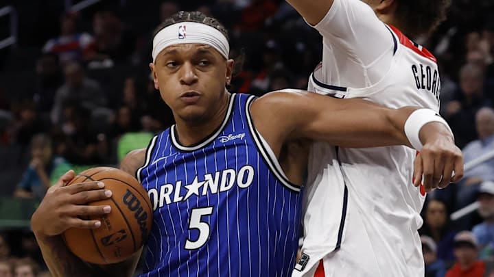 Nov 1, 2025; Washington, District of Columbia, USA; Orlando Magic forward Paolo Banchero (5) drives to the basket as Washington Wizards forward Kyshawn George (18) defends in the first half at Capital One Arena. Mandatory Credit: Geoff Burke-Imagn Images