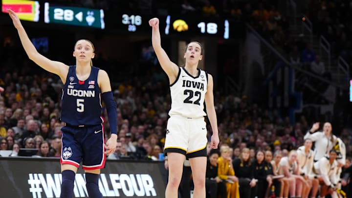Iowa Hawkeyes guard Caitlin Clark (22) and Connecticut Huskies guard Paige Bueckers