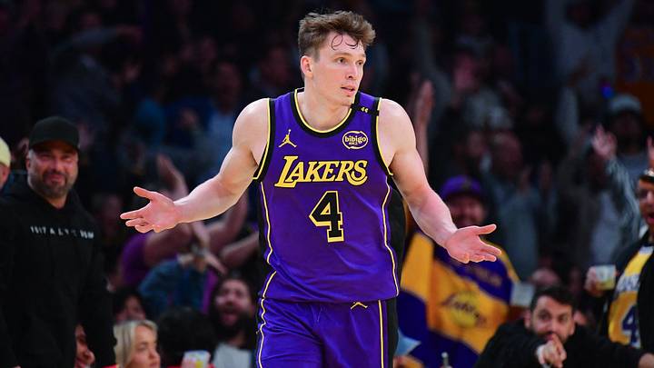 Nov 19, 2024; Los Angeles, California, USA; Los Angeles Lakers guard Dalton Knecht (4) reacts after scoring a three point basket against the Utah Jazz during the second half at Crypto.com Arena. Mandatory Credit: Gary A. Vasquez-Imagn Images