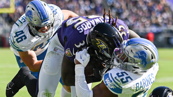 Former Baltimore Ravens running back Gus Edwards (35) runs through Lions linebacker Derrick Barnes (55) tackle attempt