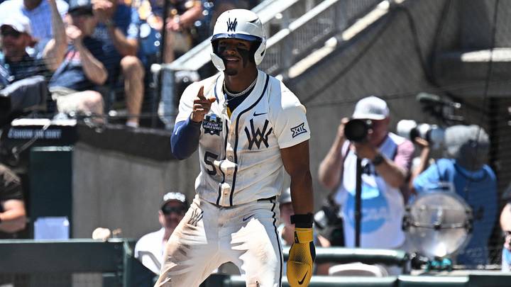 Jun 12, 2026; Omaha, NE, USA; West Virginia Mountaineers right fielder Armani Guzman (5) reacts after stealing home against the Troy Trojans during the first inning at Charles Schwab Field. Mandatory Credit: Steven Branscombe-Imagn Images Jun 12, 2026; Omaha, NE, USA; West Virginia Mountaineers right fielder Armani Guzman (5) reacts after stealing home against the Troy Trojans during the first inning at Charles Schwab Field. Mandatory Credit: Steven Branscombe-Imagn Images