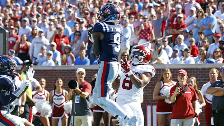 Ole Miss defensive back Trey Amos (9) catches the ball as he steps out of bounds over Sooners running back Taylor Tatum (8) 