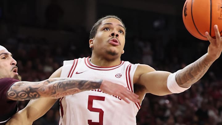 Feb 25, 2026; Fayetteville, Arkansas, USA; Arkansas Razorbacks guard Darius Acuff Jr. (5) drives to the basket as Texas A&M Aggies guard Pop Isaacs (2) defends during the second half at Bud Walton Arena. Arkansas won 99-84. Mandatory Credit: Nelson Chenault-Imagn Images