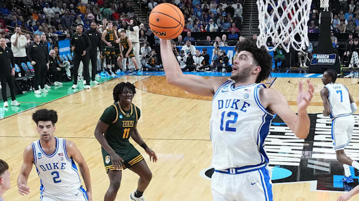 Mar 19, 2026; Greenville, SC, USA; Duke Blue Devils forward Cameron Boozer (12) grabs a rebound against the Siena Saints in the first half during a first round game of the men's 2026 NCAA Tournament at Bon Secours Wellness Arena. Mandatory Credit: Bob Donnan-Imagn Images