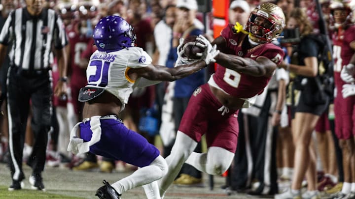  Florida State Seminoles tight end Jaheim Bell (6) catches the ball under pressure from North Alabama Lions linebacker Ashaad Williams (21) during the third quarter at Doak S. Campbell Stadium.