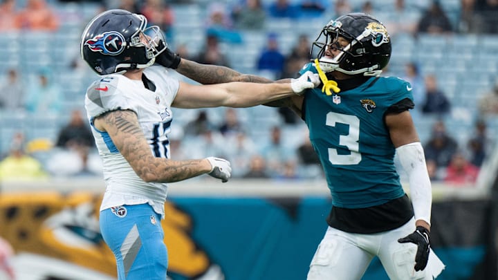 Dec 29, 2024; Jacksonville, Florida, USA; Tennessee Titans wide receiver Mason Kinsey (12) and Jacksonville Jaguars cornerback Tyson Campbell having a tussle in the third quarter at EverBank Stadium. Mandatory Credit: Jeremy Reper-Imagn Images