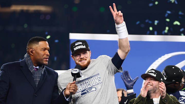 Jan 25, 2026; Seattle, WA, USA; Seattle Seahawks quarterback Sam Darnold (14) celebrates on the podium after defeating the Los Angeles Rams in the 2026 NFC Championship Game at Lumen Field.