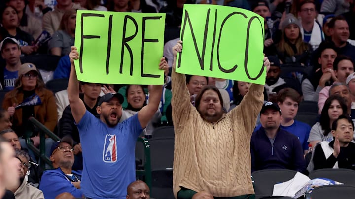 Dallas Mavericks fans with "Fire Nico" signs at the American Airlines Center