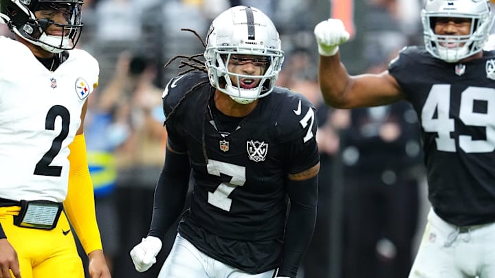 Oct 13, 2024; Paradise, Nevada, USA; Las Vegas Raiders safety Tre'von Moehrig (7) celebrates between Pittsburgh Steelers quarterback Justin Fields (2) and Las Vegas Raiders defensive end Charles Snowden (49) after making a defensive play against the Pittsburgh Steelers during the first quarter at Allegiant Stadium. Mandatory Credit: Stephen R. Sylvanie-Imagn Images