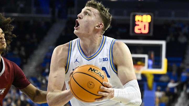 Nov 4, 2024; Los Angeles, California, USA; UCLA Bruins forward Tyler Bilodeau (34) drives to the basket as Rider Broncs guard Ruben Rodriguez (2) during the first half at Pauley Pavilion presented by Wescom. Mandatory Credit: Robert Hanashiro-Imagn Images